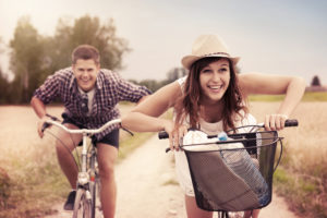 Happy couple racing on bikes